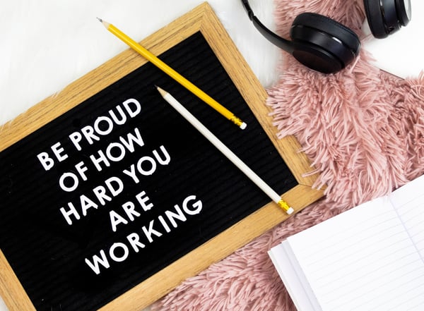 "Be proud of how hard you are working" sign