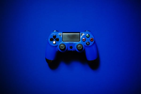 Blue PS4 controller on blue background