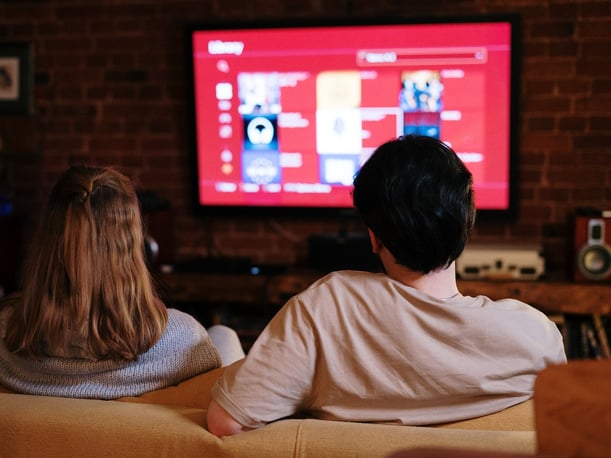 Couple sitting in front of tv
