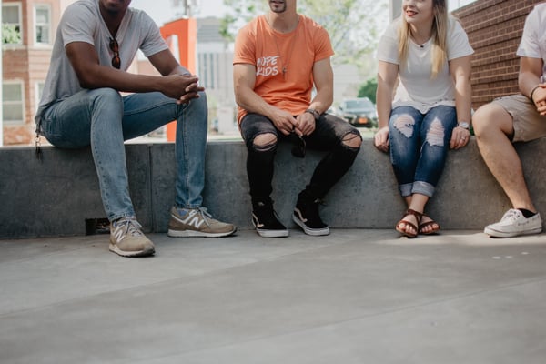 Four people sitting and talking