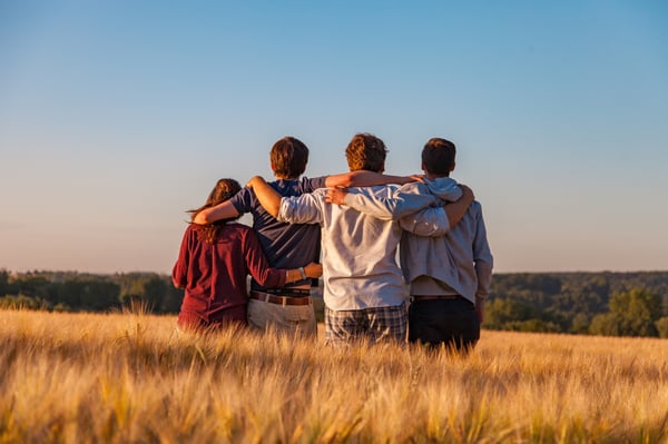 Friends sitting together with linked arms