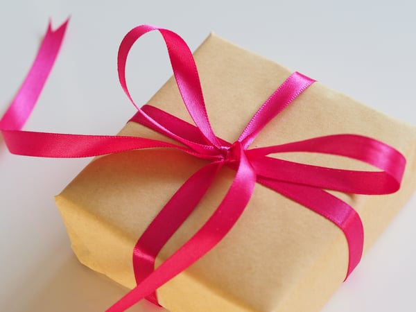 Gift wrapped in brown paper with pink ribbon