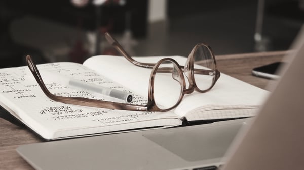 Glasses resting on a notebook