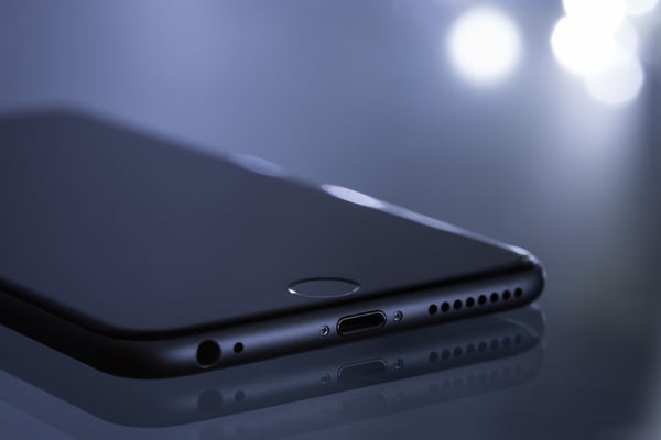 Gray iPhone on dark background