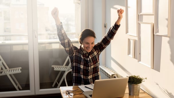 Happy woman in front of laptop