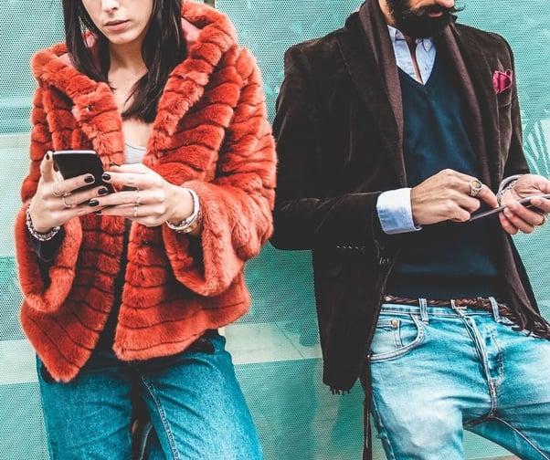 Woman and man on their phones