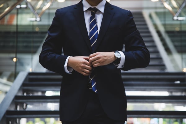 Man closing his suit buttons