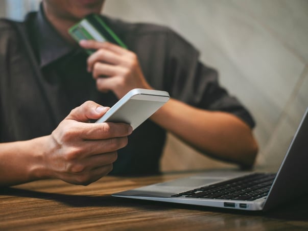 Man holding green credit card