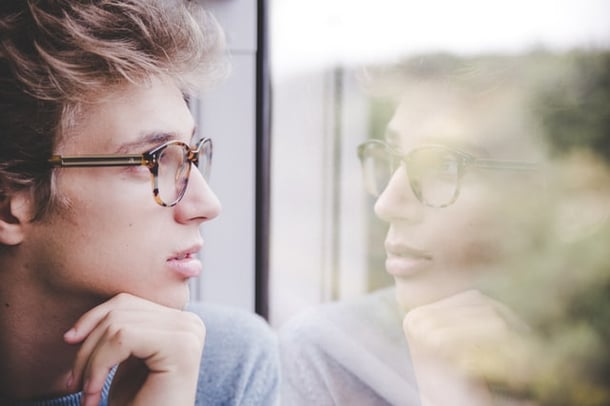 Man looking at his own reflection