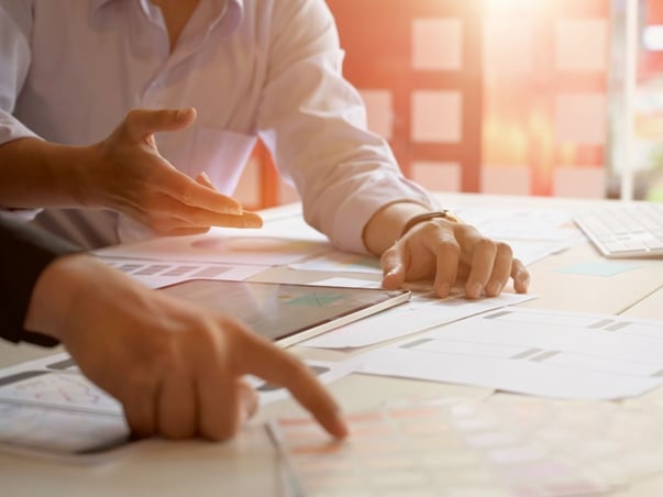 Man pointing on paper from the desk