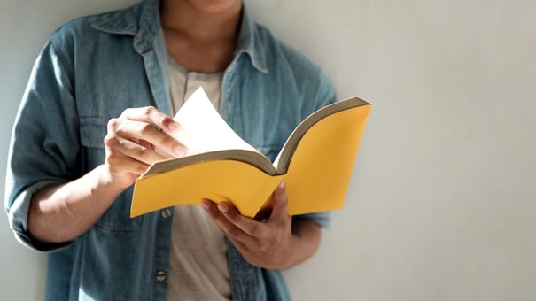 Man reading a yellow book