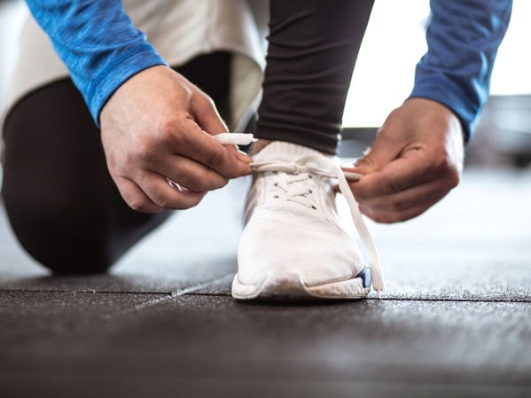 Man tying his shoe