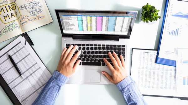 Man typing data on laptop