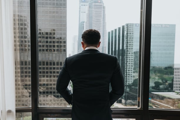 Man wearing a suit looking out of the window