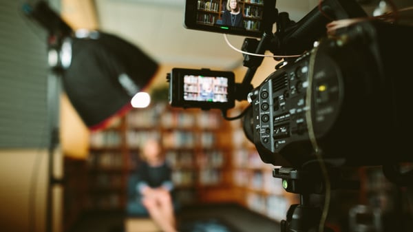 Person filming in library