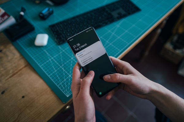 Person holding smartphone with notifications