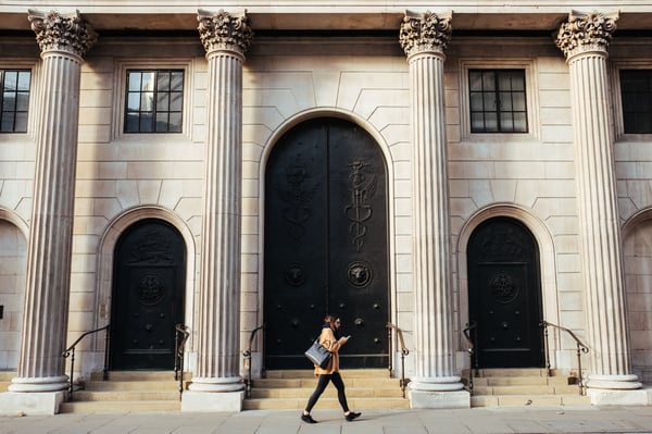 Person walking between pillars