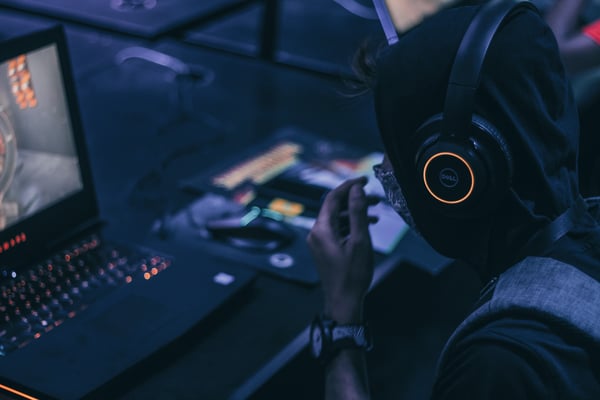 Person wearing headphones playing PC game