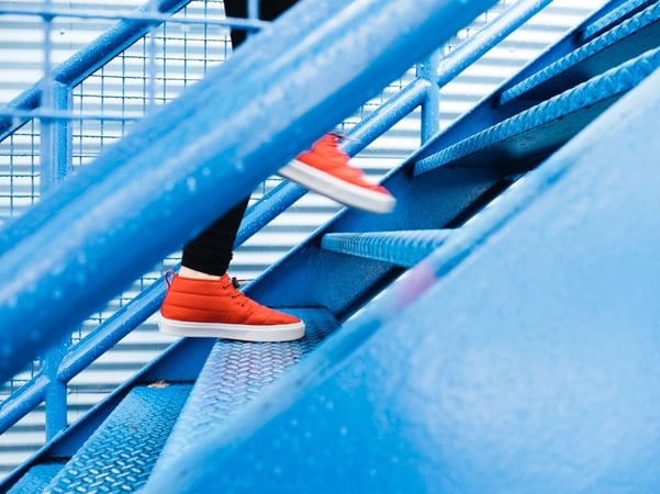Person with red shoes walking on stairs