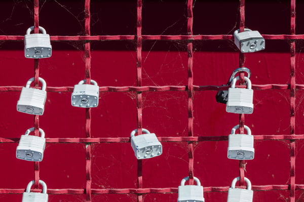 Red fence with locks on it