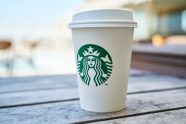 Starbucks cup sitting on pier