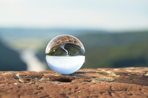 Transparent orb sitting on rock shelf