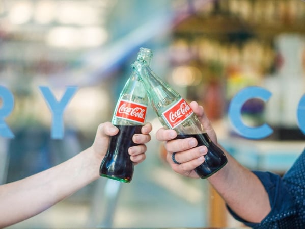 Two people drinking coca cola