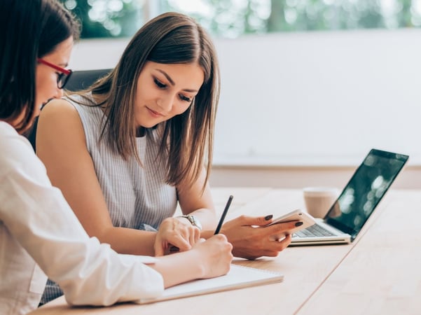 Two women working together