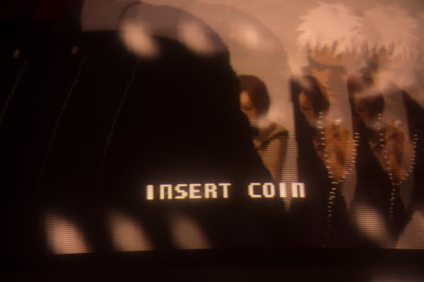 Video game screen reading "insert coin"