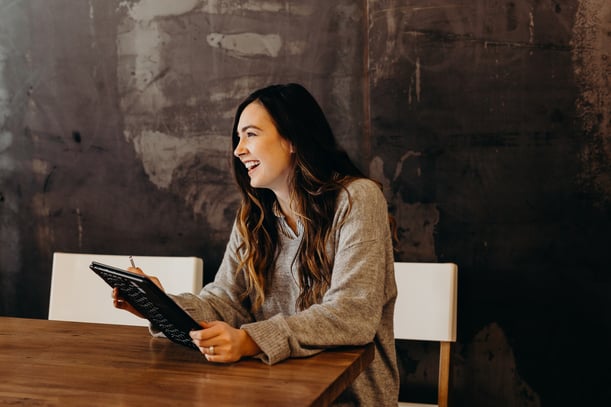 Woman smilling sitting on a chair