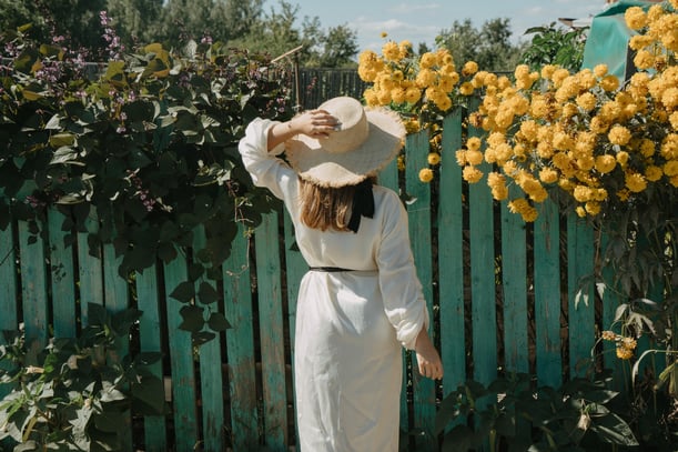 Woman standing in front of yellow flowers