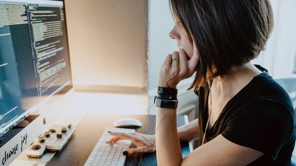 Woman thinking in front of pc