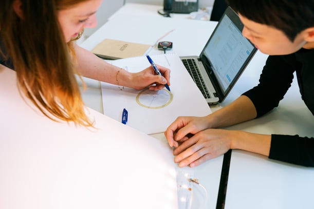 Women discussing on a desk