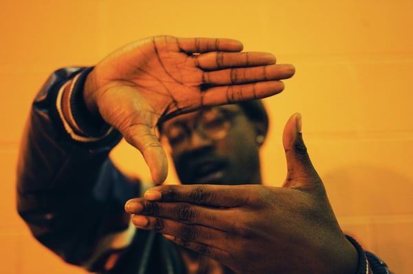 Man framing portrait with hands