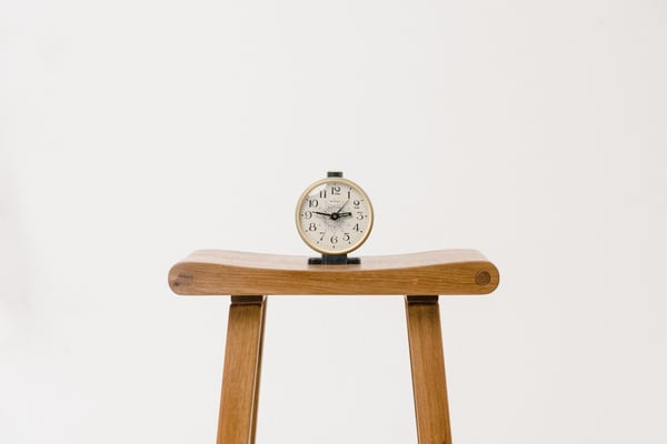 Clock on wooden stool
