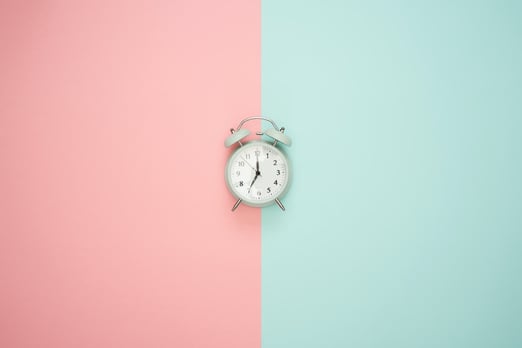 clock on pink background blog post