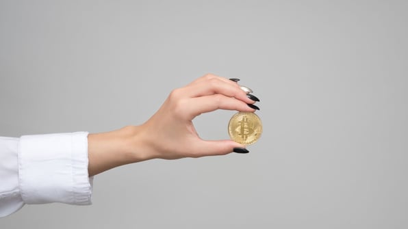 hand holding bitcoin