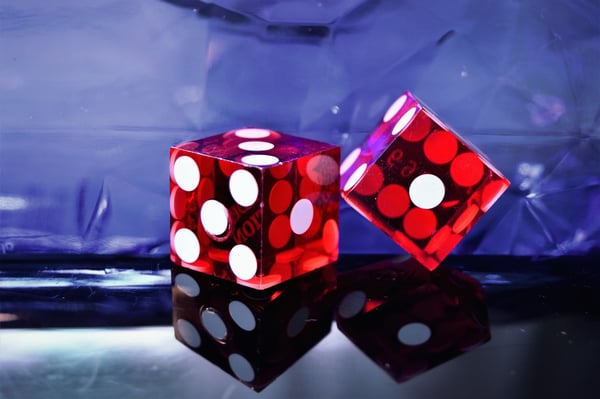 Red dice on dark background