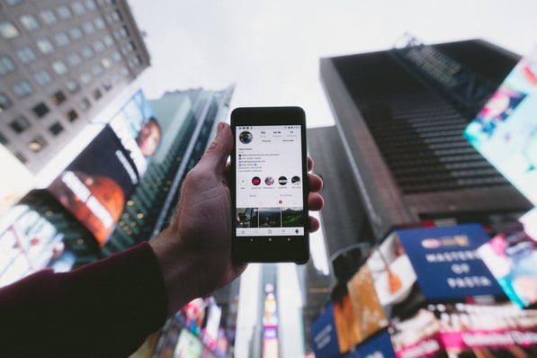 man holding phone in the street