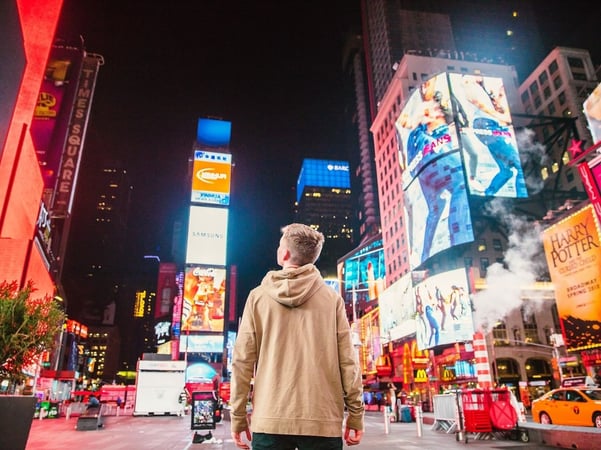 man looking at street ads