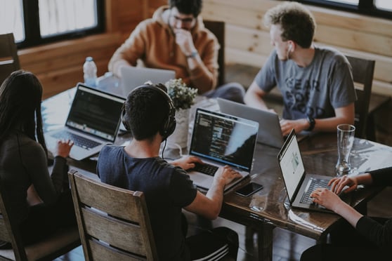 People at desk with laptops